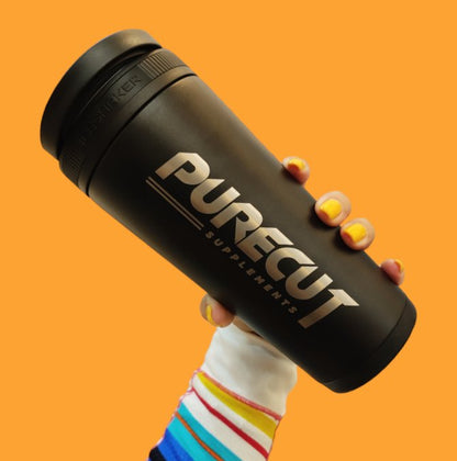 PureCut Shaker held by hand on orange background